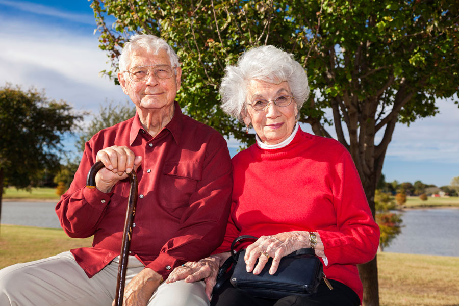 Elderly man and woman smiling at the camera