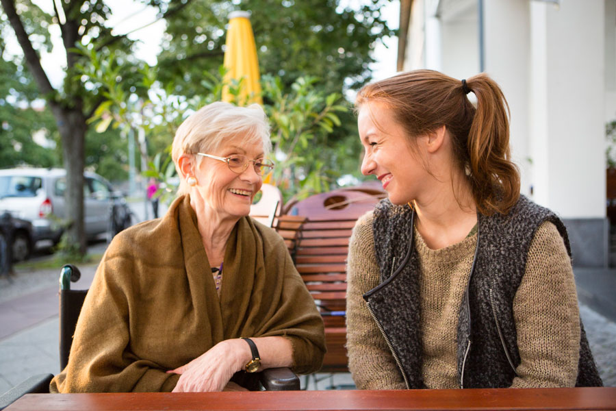 Elderly woman talking with younger woman