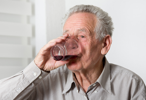 Close up of old man drinking wine