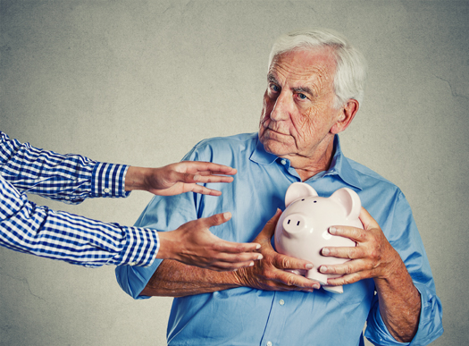 Closeup portrait senior man grandfather holding piggy bank looking suspicious trying to protect his savings from being stolen isolated on gray wall background. Financial fraud concept "n