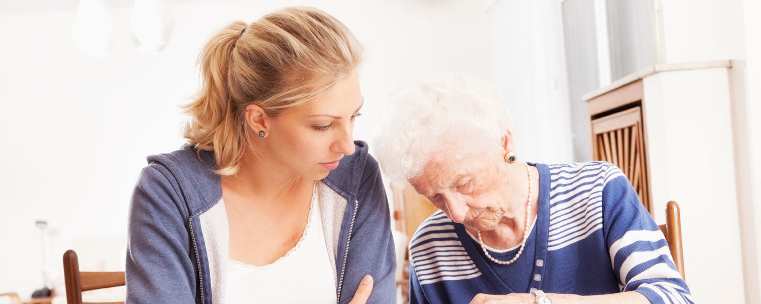 Elderly woman and younger woman working on a craft